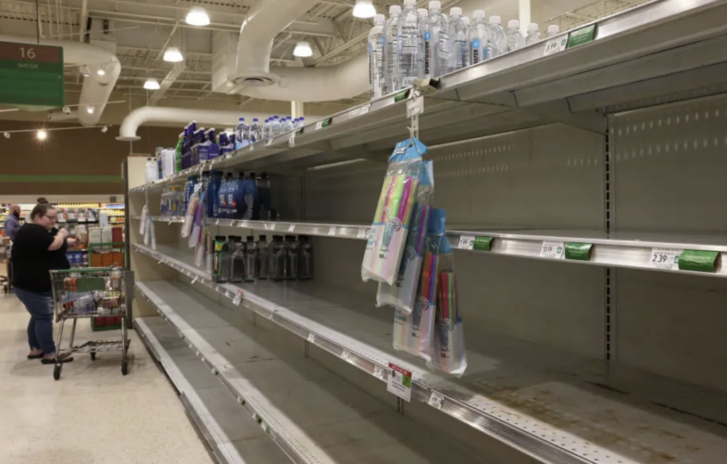 Customers check mostly empty bread shelves at a shopping warehouse in Kissimmee, Florida on October 6, 2024.